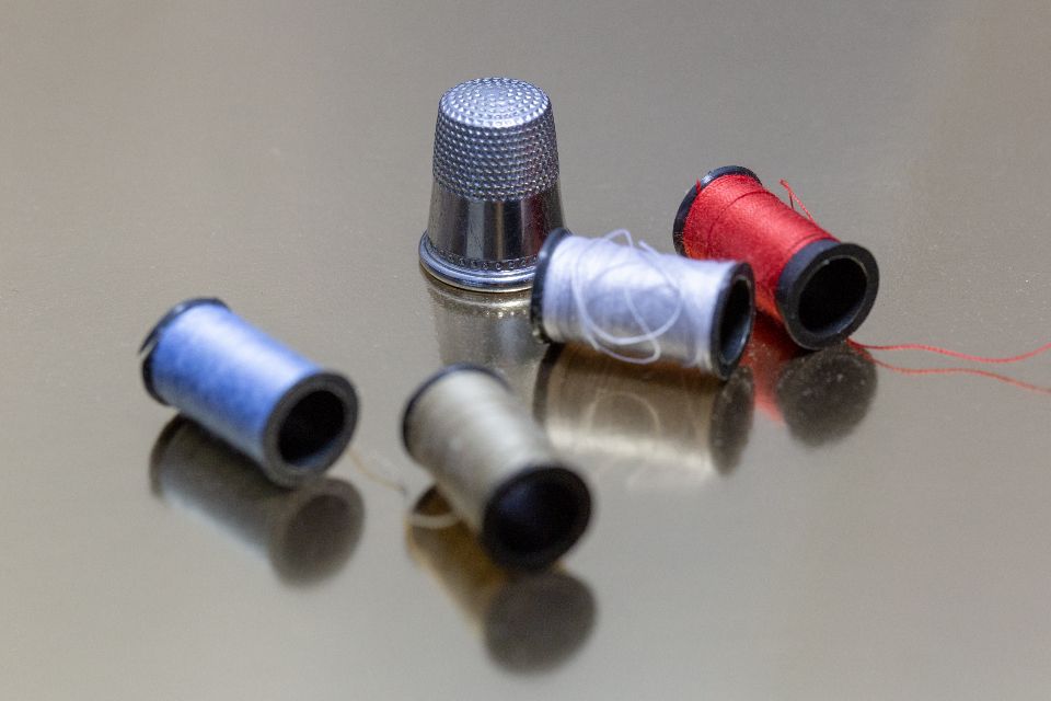 Spools of thread and a thimble